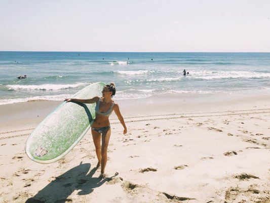 Salon owners have to have fun too! Surfing in Kitty Hawk Nc.