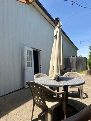 Torn and worn patio umbrella and chipped plastic tables :(