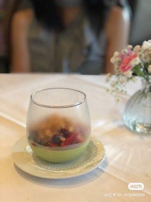 Pistachio panna cotta with red berries and almond crumbles