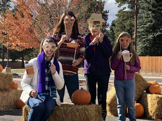 Connie Sims, Renae Trichell, Jackie Brown posing with photo props at their free pumpkin patch for their real estate clients in Woodland Park