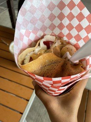 Crepe with whipped cream, 2 toppings (fruits being strawberries and bananas), with a coat of Nutella