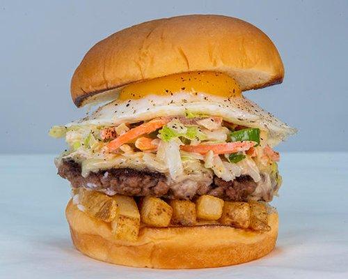 SLAW BURGER - impossible™ patty, white american cheese, fries, haus slaw, fried egg, mayo