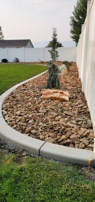 Planting area with concrete curbing and woodstone