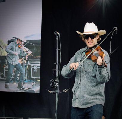 Kyle fiddles on stage