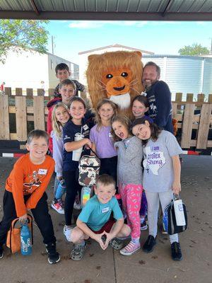 Our students with our mascot, Leon the Lion.