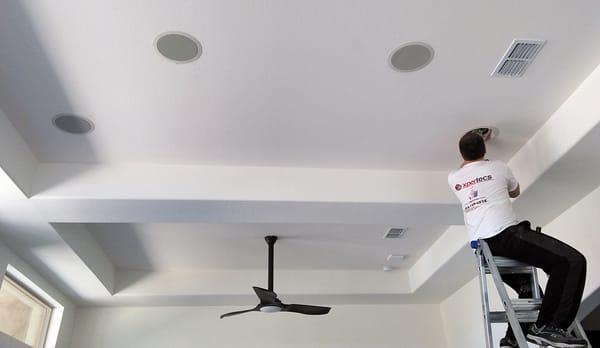 Installing ceiling speakers.