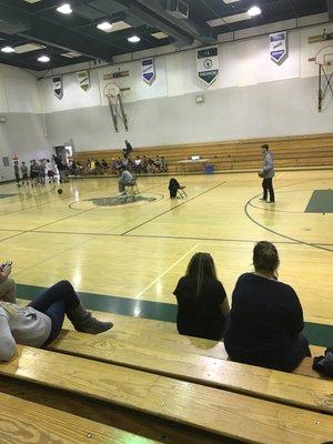 Empty half court with an employee messing around.