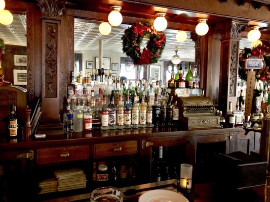 The main bar in the dining area. Love the ancient cash register!