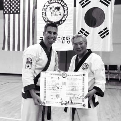 Master Dufour being promoted to six degree black belt by his instructor, Grandmaster C S Kim.