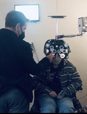 Dr. Lockhart is fine-tuning a patient's corrective lenses using his state-of-the-art equipment.