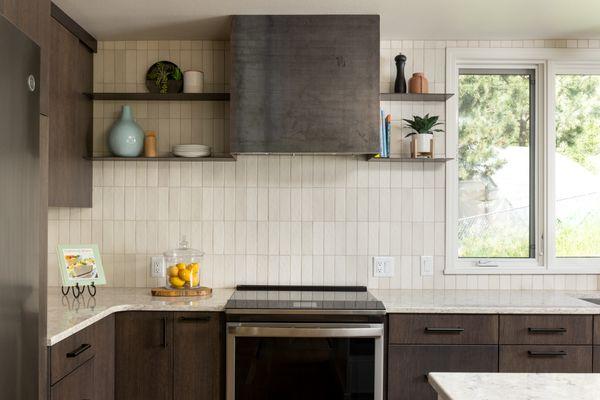 Modern kitchen remodel with custom steel hood.