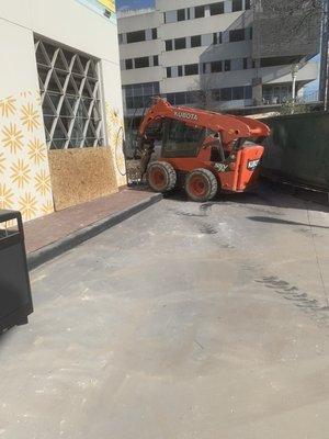 Demotion work done in downtown Austin breaking concrete and hauling.