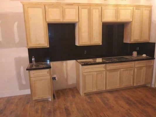 Finish cabinets with full backsplash kitchen Countertops black galaxy.