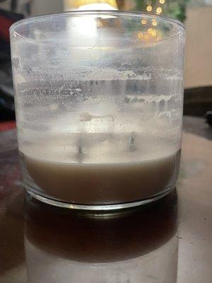 Back of candle showing burn is not clean, and level of wax I'm unable to burn.