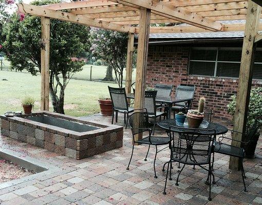 Replaced wood deck with stone pavers and pergola in Simonton, TX. Includes flower boxes