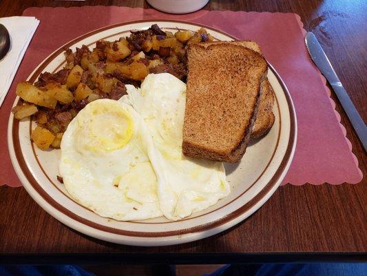 Homemade corn beef hash, 2 eggs over medium, wheat toast.