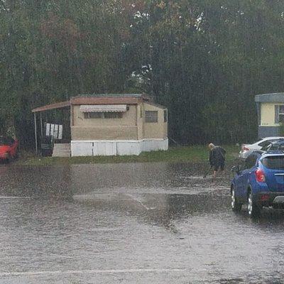 Yup this is what the streets look like when it rains. Yes, that man is mid calf deep trying to unclog street drains!