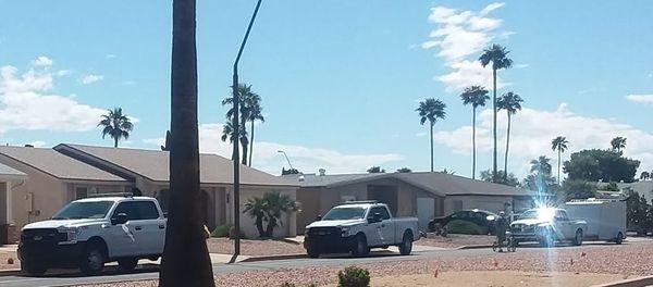 Two city trucks checking on our electrician situation