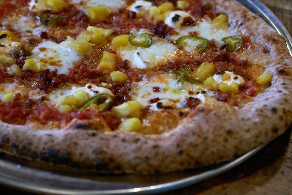 The Pineapple with tomato sauce, ricotta cheese, fresh mozzarella cheese, parmesan cheese, pickled pineapple, jalapeno, and guanciale.