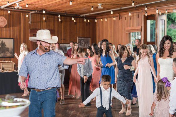 Line dancing at a wedding reception.