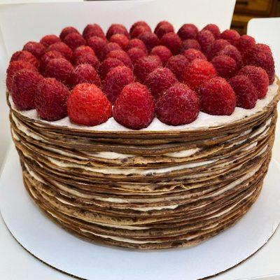 Chocolate crepes with sweet cream and raspberries