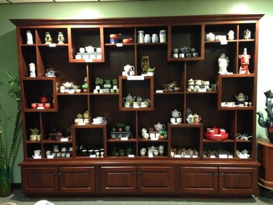 One of the three wall shelves on the showroom showing teapot sets and other Chinese decor.