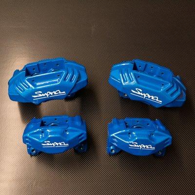 Toyota Supra calipers refinished metallic blue with white lettering.