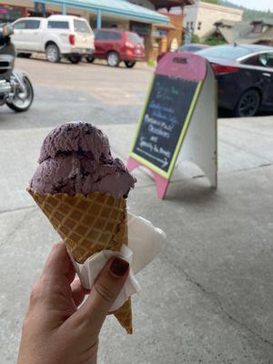 Enjoying the Huckleberry ice cream in a waffle cone in the outdoor seating at Sugar and Spice