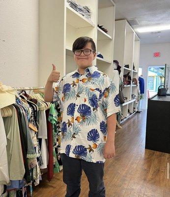 A very cute young man who loves his new Hawaiian shirt!