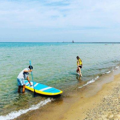 Getting set to stand-up paddleboard Lake Michigan! Check out the St. Joseph lighthouse!