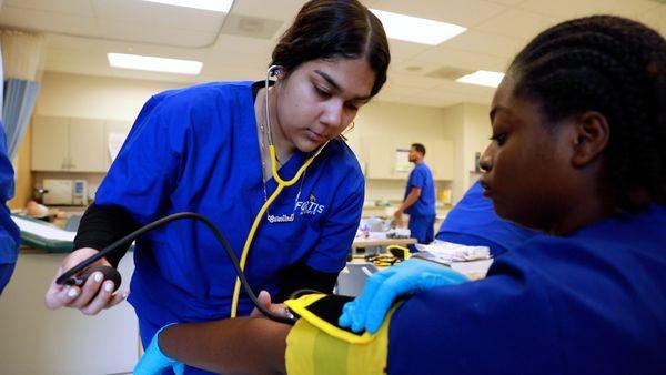 Medical Assisting students practicing in classroom