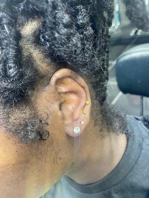 two ear piercing at the top