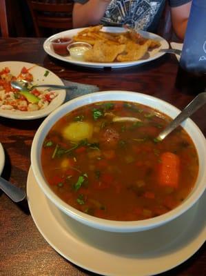 Huge delicious seafood soup. Spicy! But good.  Cancun plate in the background.  My son declared best ceviché ever.