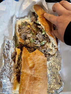 Giant Philly cheesesteak w/peppers and onions on a freshly baked grinder roll