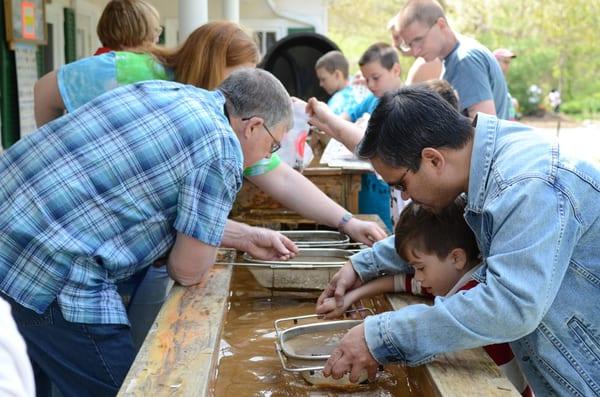 Kids pan for gemstones during a birthday party at CSTL