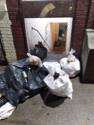 The super won't spend a few bucks on a new lock, people can't fit their key into the rusted lock, so the garbage piles up on the sidewalk.