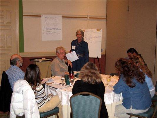 Founder Kathleen Oweegon facilitates meeting.