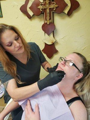 One of our lovely clients getting her lips filled by our lead injectionist, Teresa.