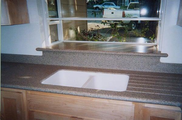 Corian counter with integral Corian sink and window sill. No seams or exposed caulk quick clean up.