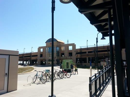 The parking garage, bike parking, and bus stop at the Light Rail terminal.