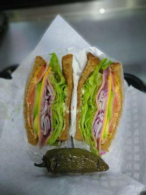 Delicious Turkey sand. Avocado mayo lettuce tomatoes mustard onions and of course a jalapeno. Bomb