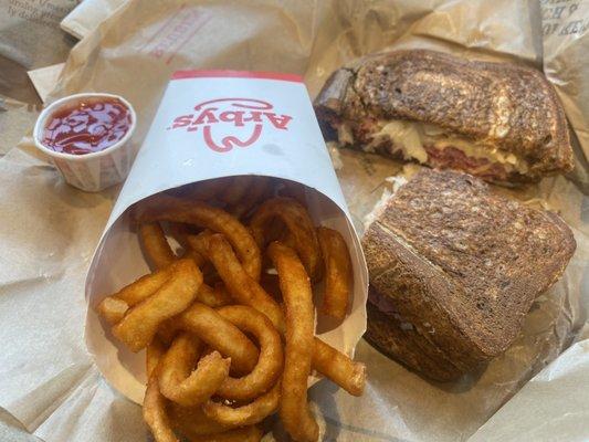 Reuben sandwich and curly fries