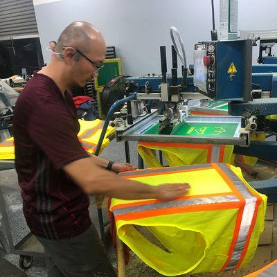 Screen printing safety hi-visibility vests for a construction company here in Jacksonville