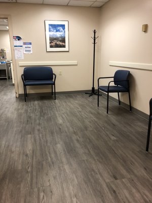 Socially distanced waiting room. Table and magazines have been removed.