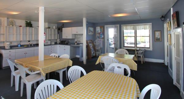 This is a community kitchen and family room for motel guests to enjoy, keep food, play cards and make simple meals with a microwave oven.