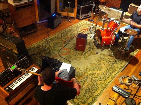 Looking in on a session in the Live Room. 16' ceilings and hard wood floors. Big enough for any band setup, or choirs. A great sounding room