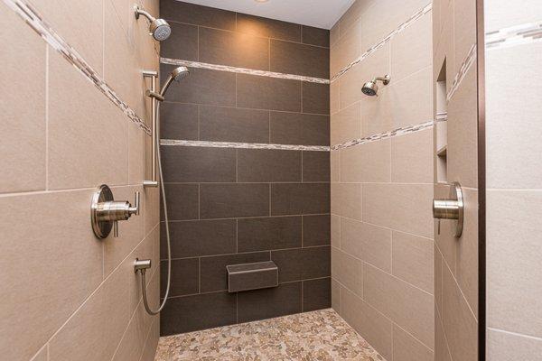 A dream shower with accent tile mosaic floor and band