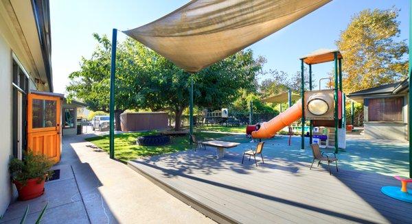 Play yard.  2 play structures. Lots of shade.  Beautiful tree and grass.