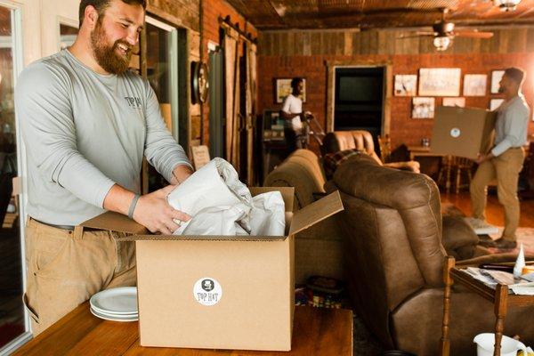 Austin cracking a smile as he packs for one of our clients.