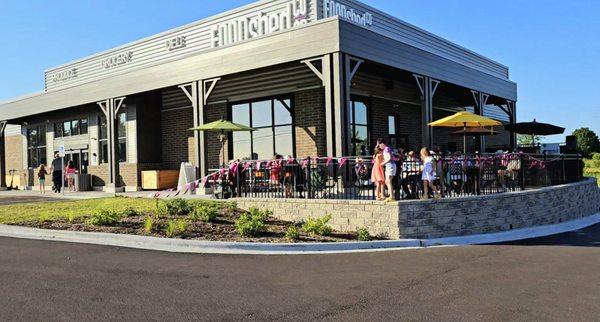 Co-op visitors enjoy the spacious patio in the fresh evening air while listening to live music and enjoying a tasting event.